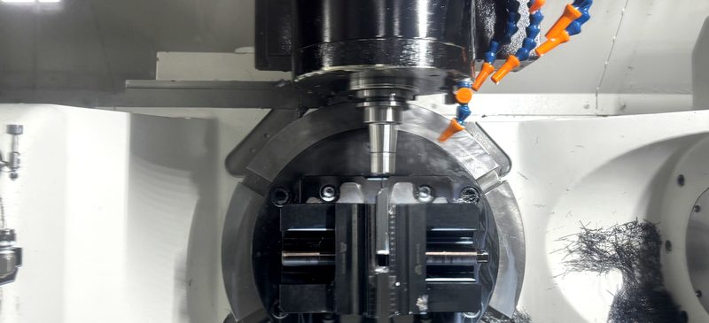 Close-up of 5-axis machining operation with coolant nozzles and tool engagement