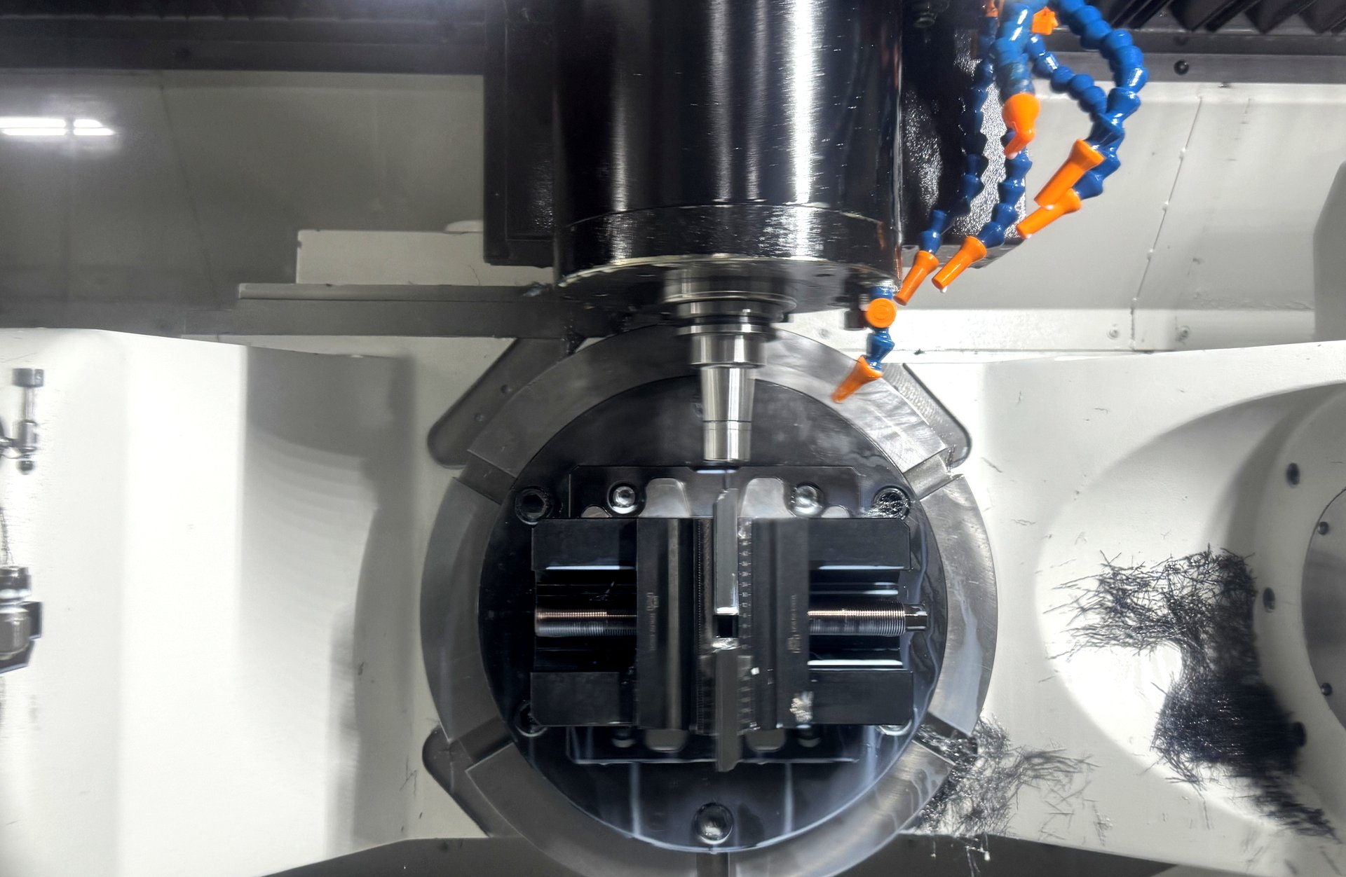 5-axis CNC machine with trunnion table, part fixtured for multi-face machining