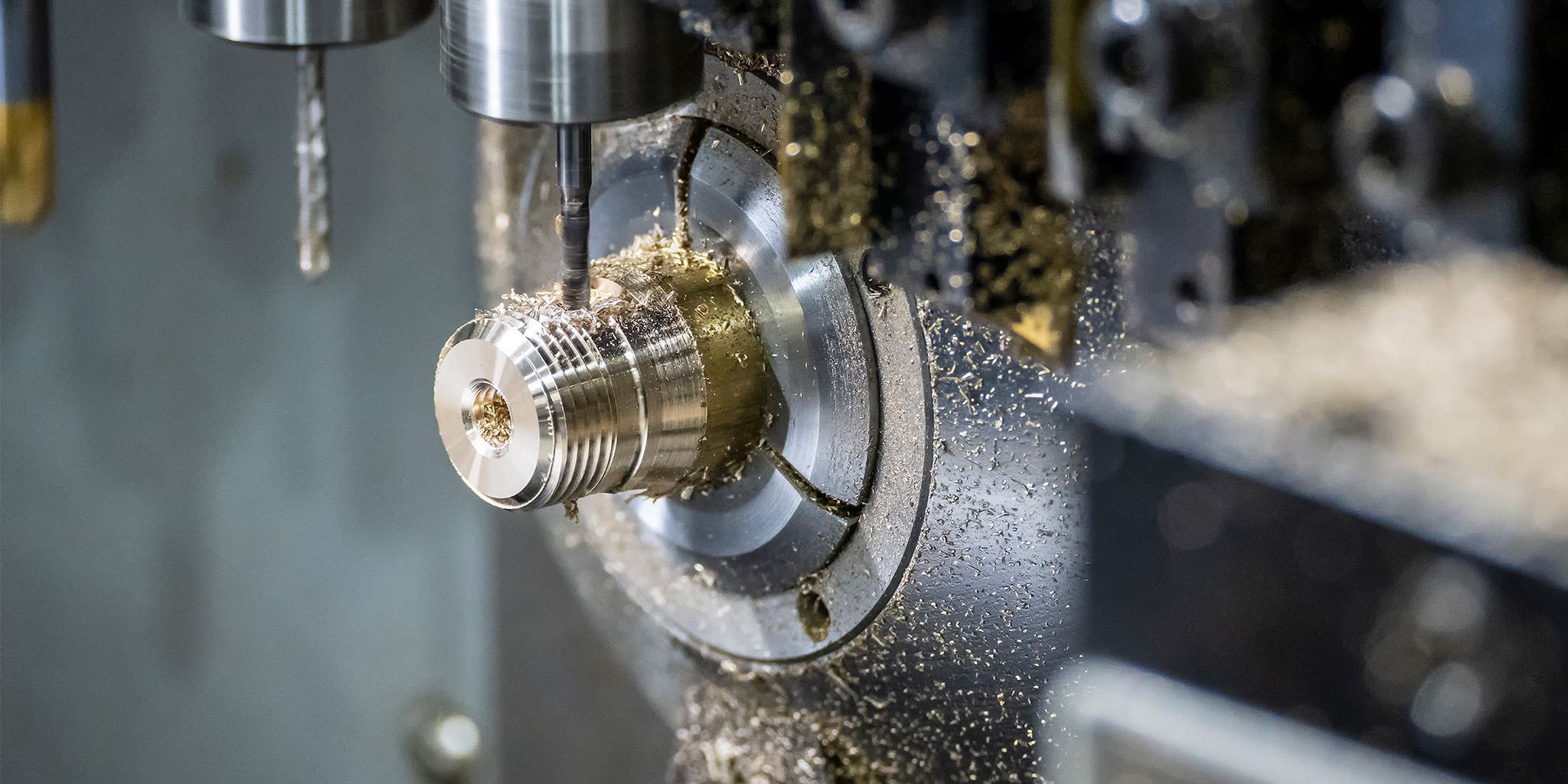 CNC lathe with live tooling performing simultaneous turning and milling operations