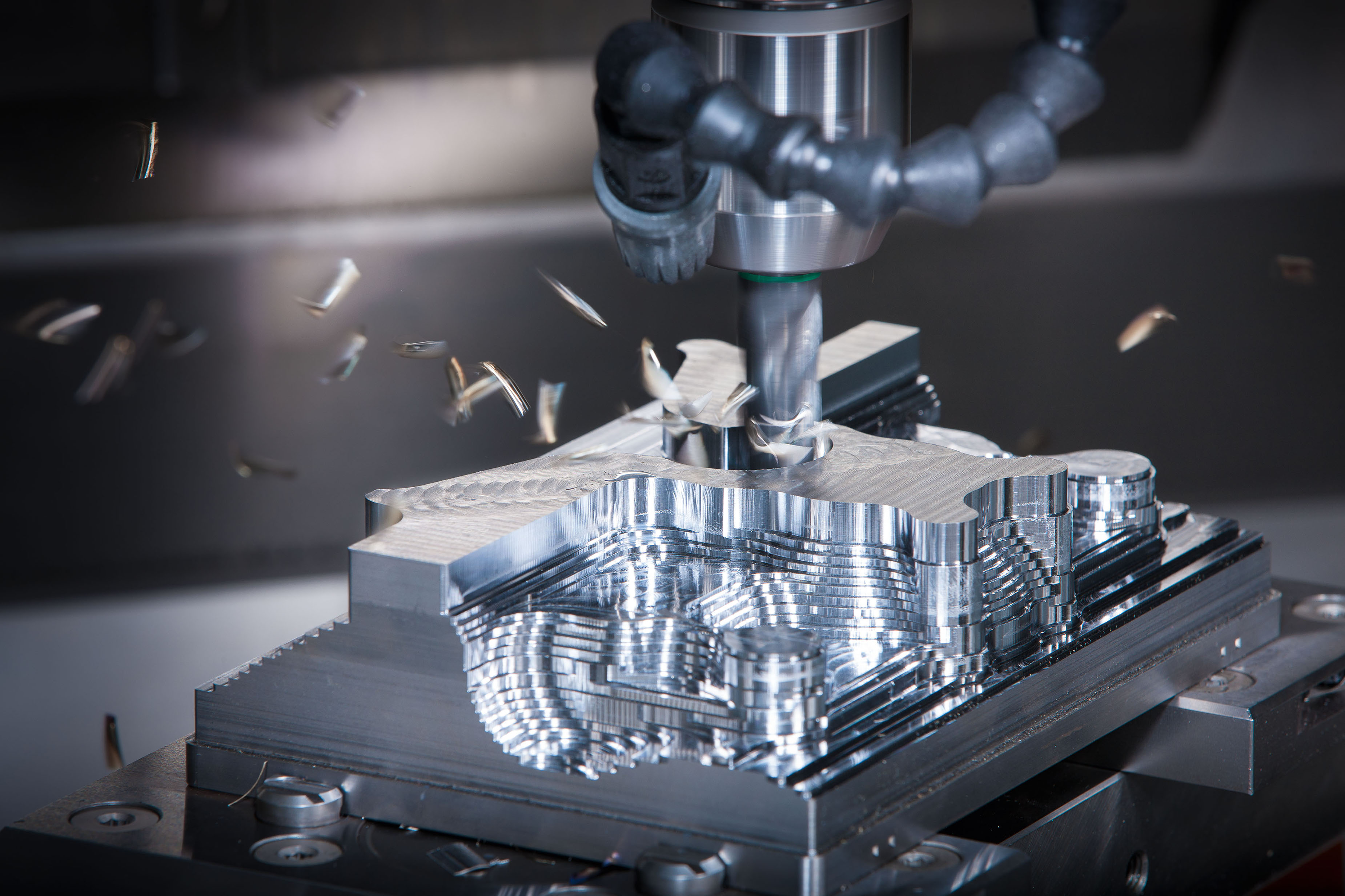 CNC milling operation cutting precision geometry with chips flying