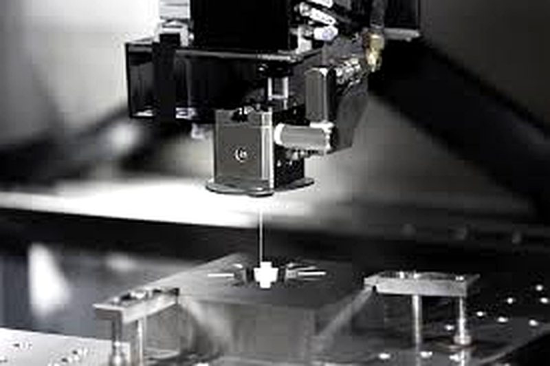 Wire EDM machine cutting through hardened tool steel